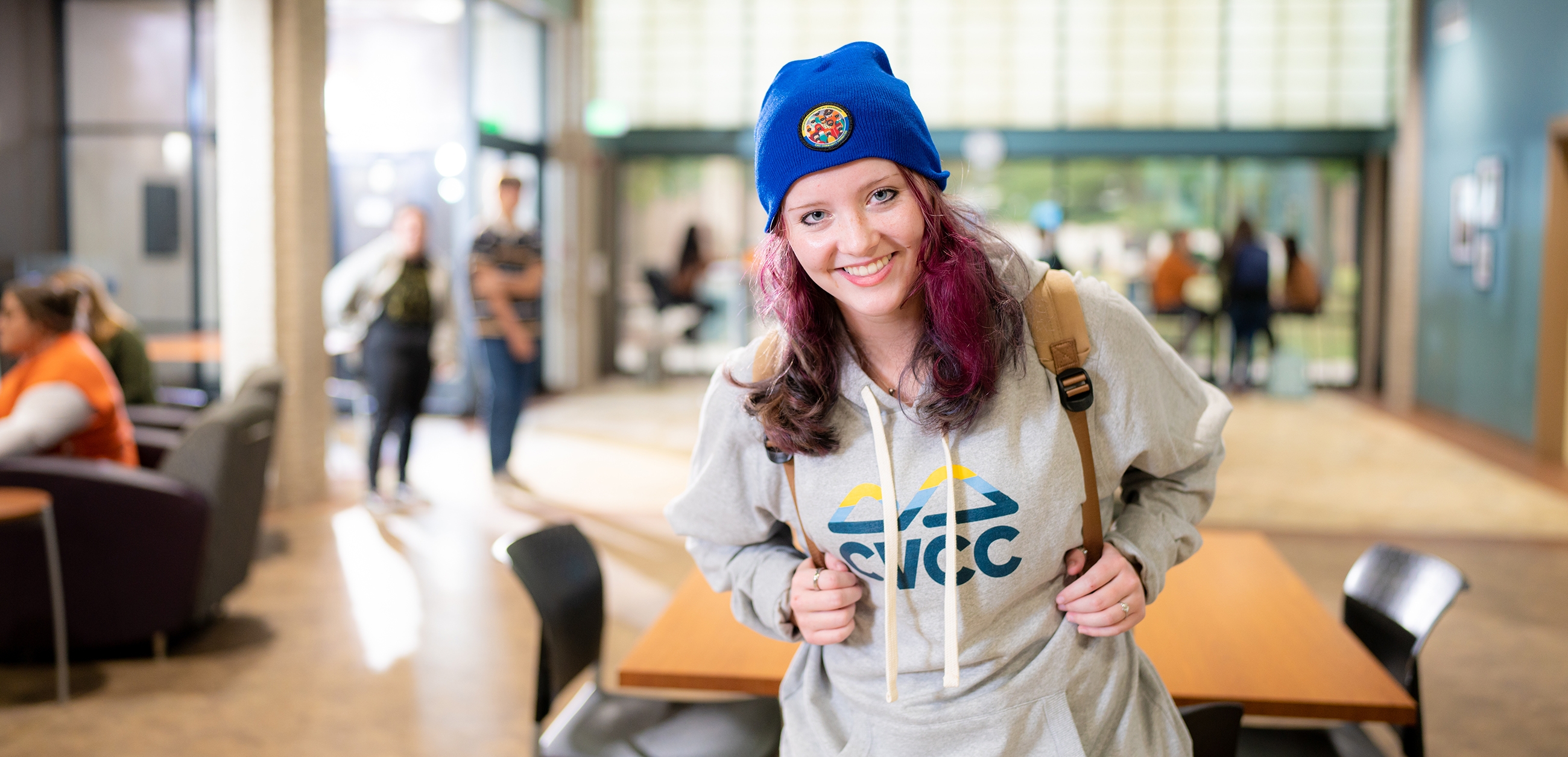 Female student with backpack and hat